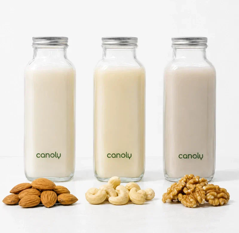 Almond milk, cashew milk, and walnut milk in glass bottles