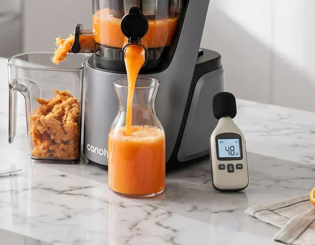 Slow_masticating_juicer_running_on_kitchen_counter_beside_a_sound_level_meter_reading_48_decibels